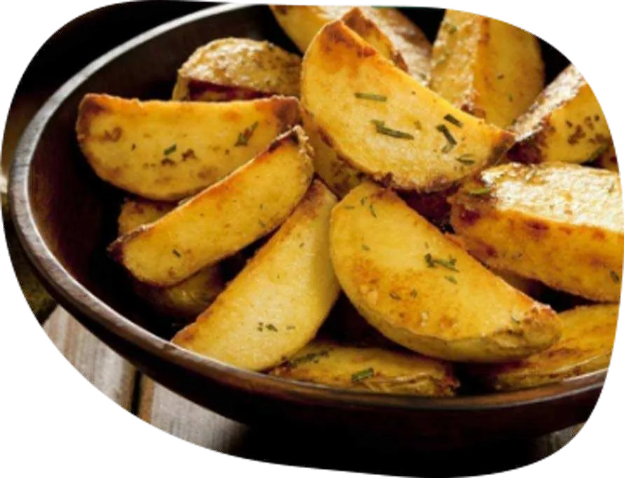 Batatas rústicas assadas em gomos, douradas e temperadas com ervas, em panela.